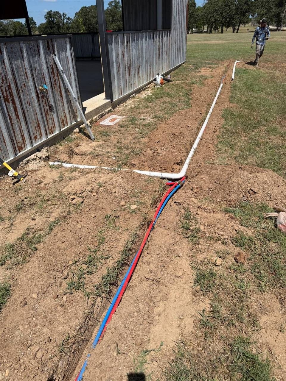 Irrigation trench and lines being installed